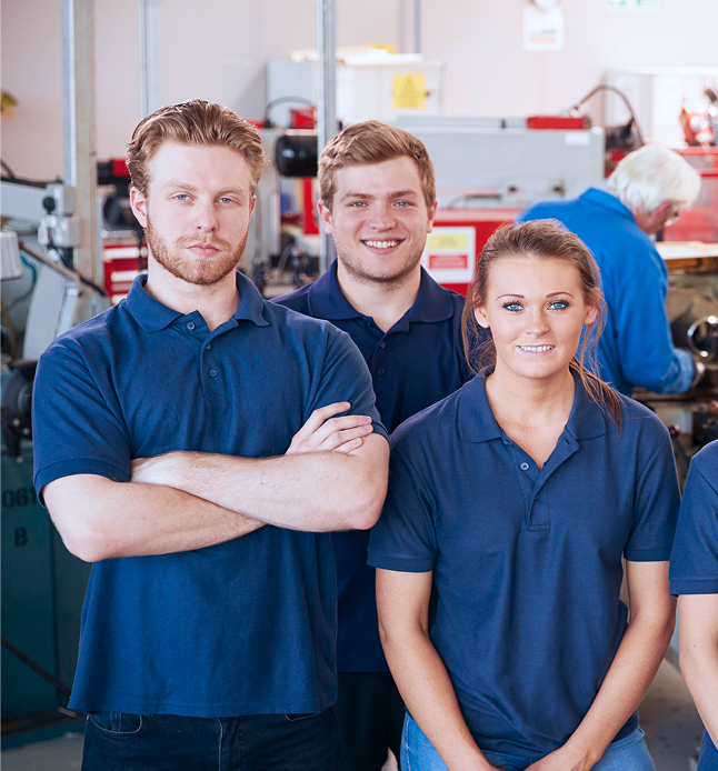 A diverse group of people working together in a factory setting, engaged in various tasks and operations.